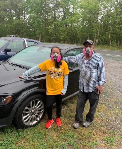 In & Out Autobody technicians outside the family-owned auto body shop in Gordonsville, Virginia